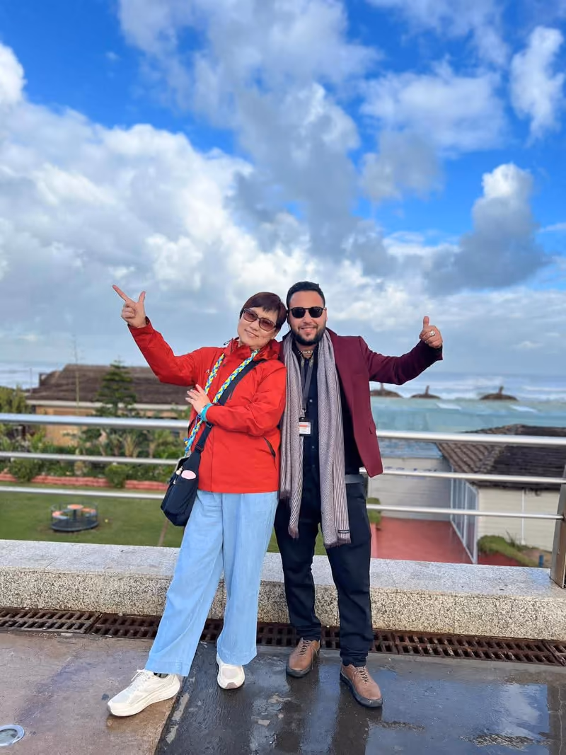 Two guests laughing on a windswept Atlantic terrace